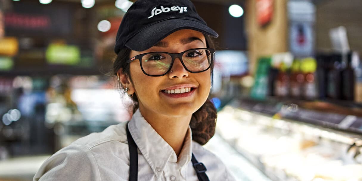 A Sobeys teammate smiling and posing for the camera